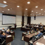 a photo showing participants in a lecture room listening to a presenter talking about the introduction,